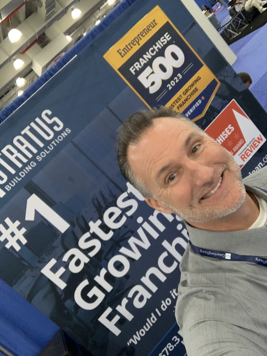 Mike Millett at a Stratus Building Solutions trade show booth under the old name